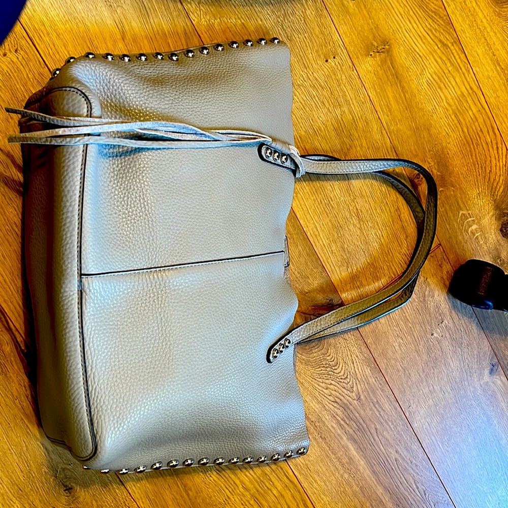 Rebecca Minkoff grey tote with stuffing. Unfinished Interior w attached pocket.